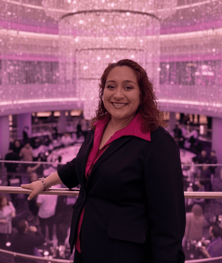 Casino Manager Anita Gutierrez in front of a magenta chandelier on the upper level