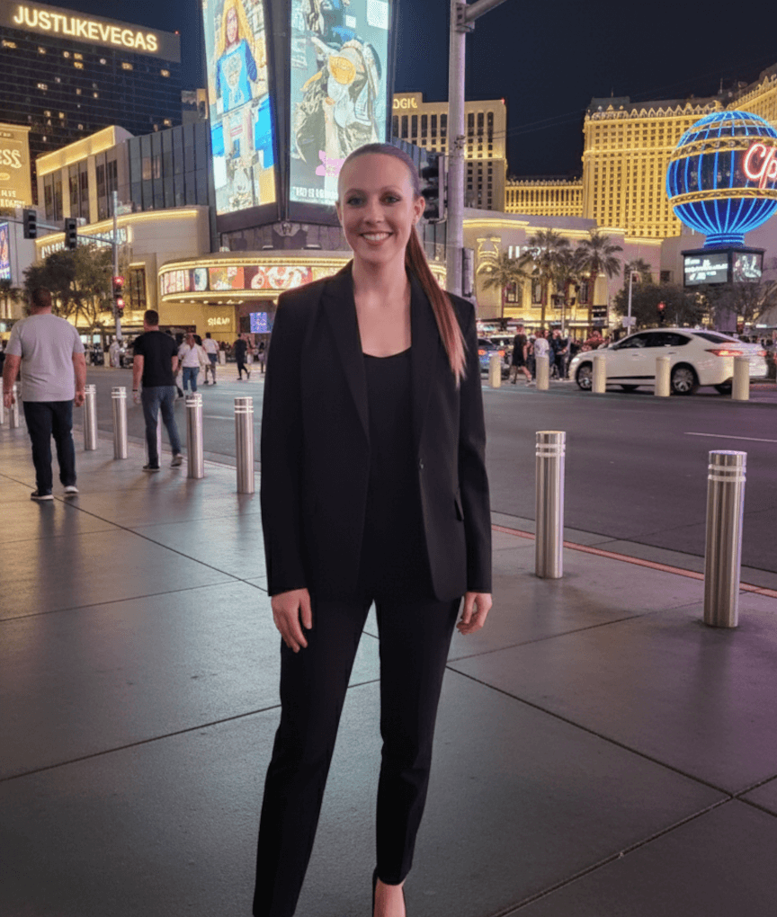 Casino Lead Erin Biddle standing on the Las Vegas Strip at night with casino lights in the background